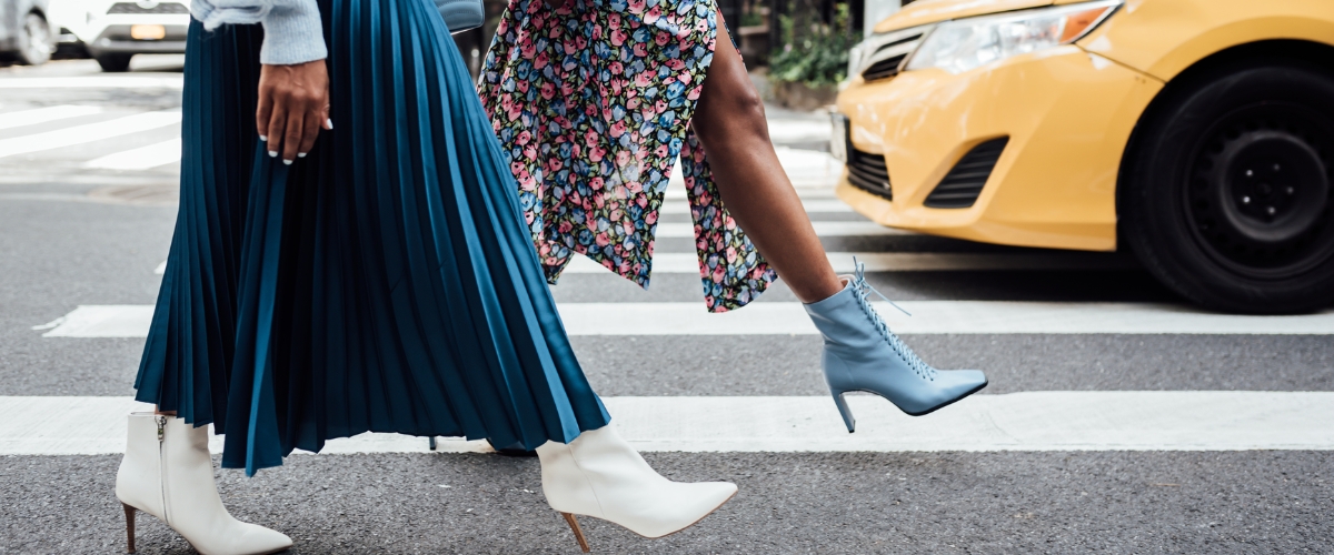 young women walk through city